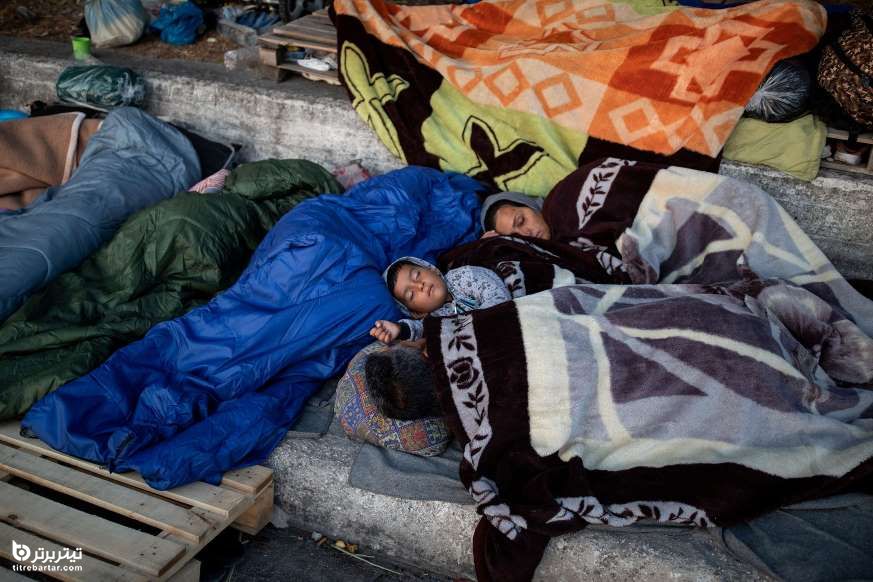پناهندگان و مهاجران اردوگاه تخریب شده موریا در کنار جاده ای در جزیره لسبوس، یونان